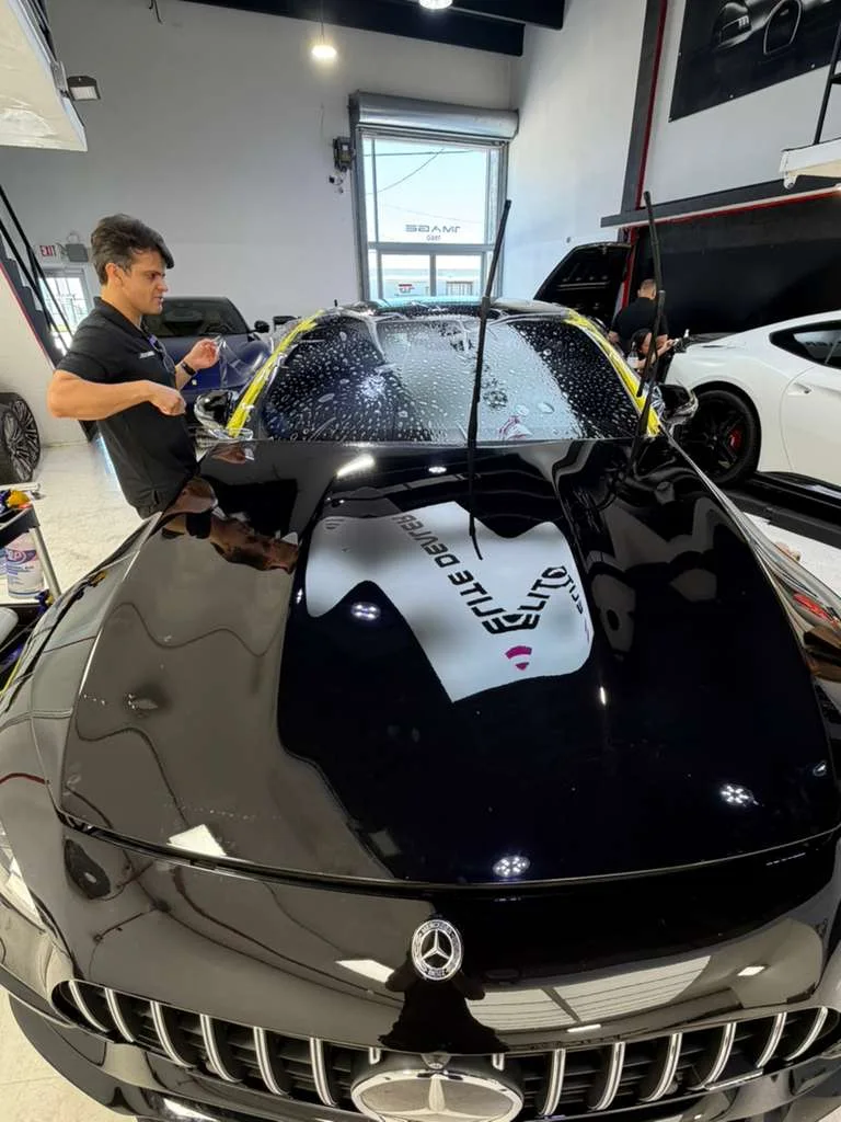 PPF install on a black Mercedes-AMG GT windshield