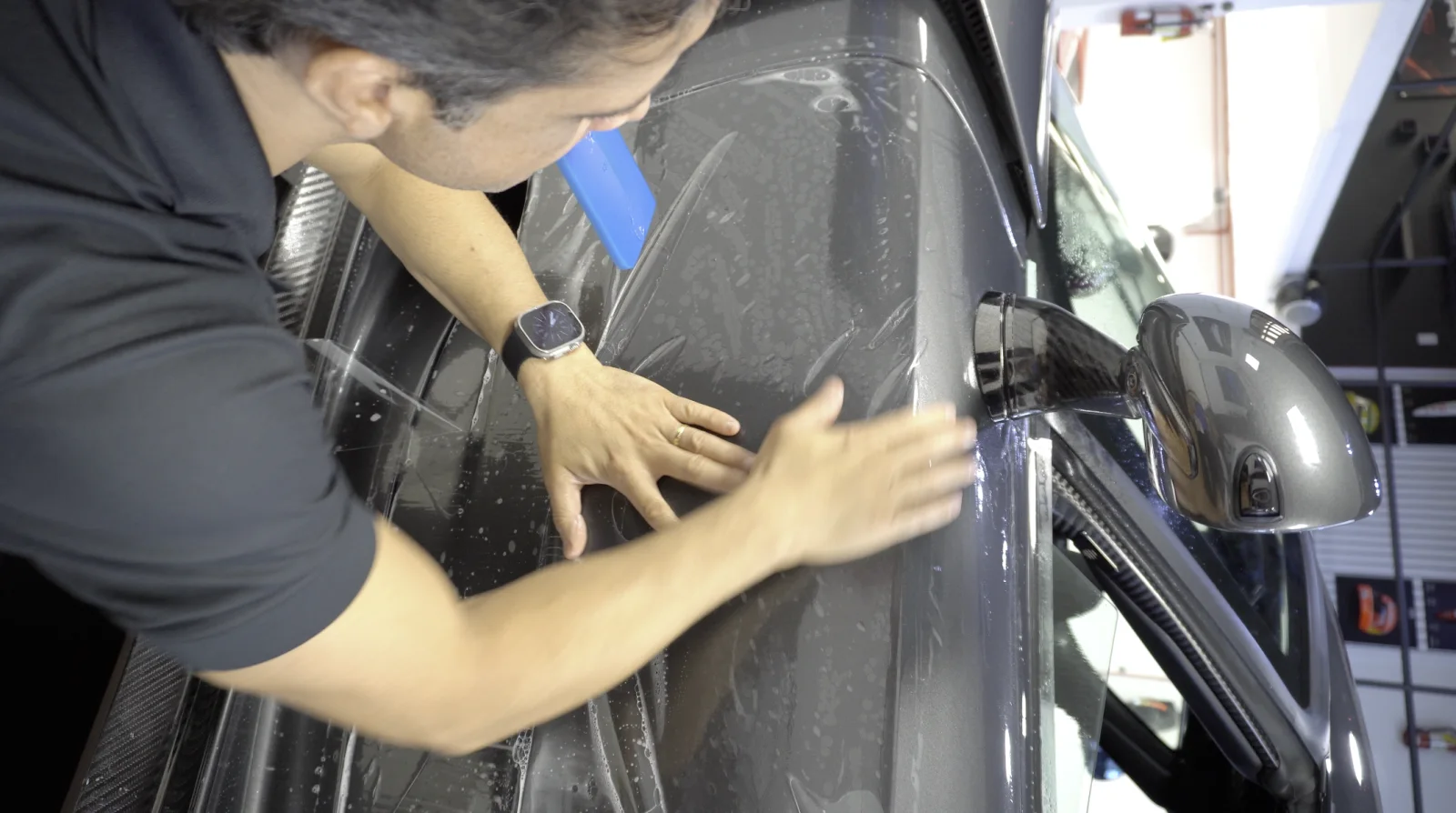 Paint protection film wrapped around a mirror and A-pillar